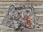 Camouflage shorts with BD Athletic Dept text and logo on a wooden surface