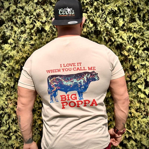 Man wearing a t-shirt with 'I Love It When You Call Me Big Poppa' design and a cap with Coors branding.