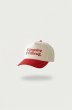 Beige and red snapback hat with 'Expensive and Difficult' text on a white background