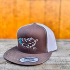 Rootbeer and white snapback cap with teal and white feather design on a wooden surface