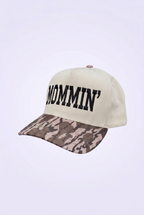 Snapback hat with 'MOMMIN' text on a white background
