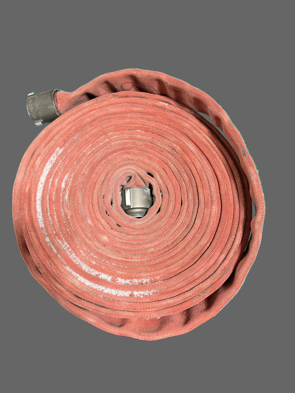 Roll of red firehose on a gray background