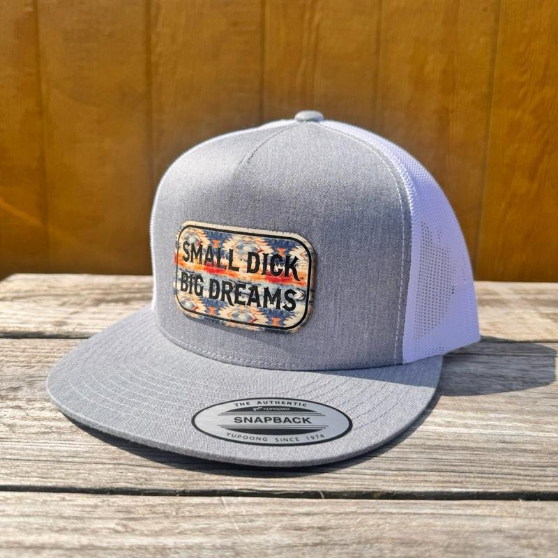 Heather grey and white snapback hat with 'Small D*ck Big Dreams' patch on a wooden surface