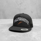 Black snapback hat with 'YALLTERNATIVE' text and lightning bolt on a countertop background