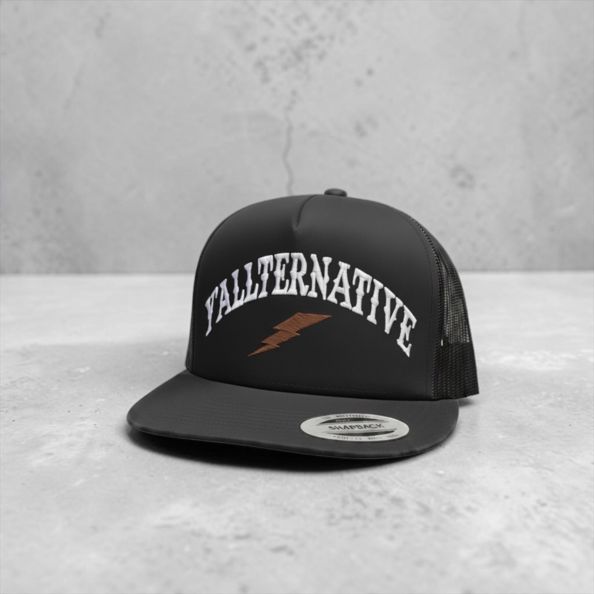 Black snapback hat with 'YALLTERNATIVE' text and lightning bolt on a countertop background